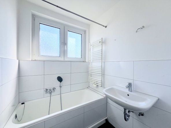 Wohnung mieten in Aachen-Forst Badezimmer mit Badewanne und Waschbecken, Weissem Fliesenspiegel und Tageslichtfenster